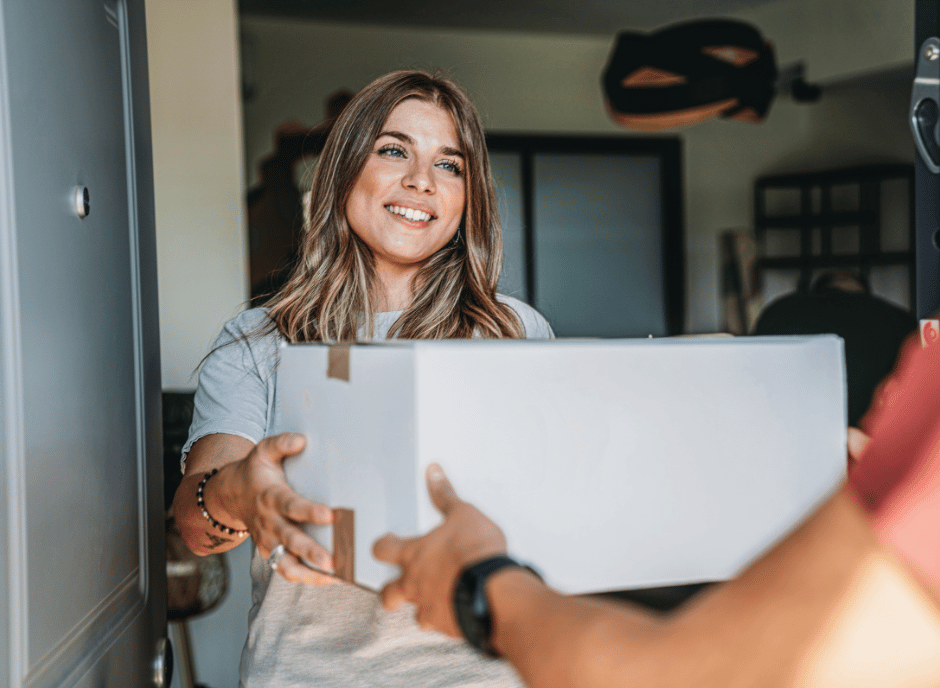woman receiving a package from a drive yello courier