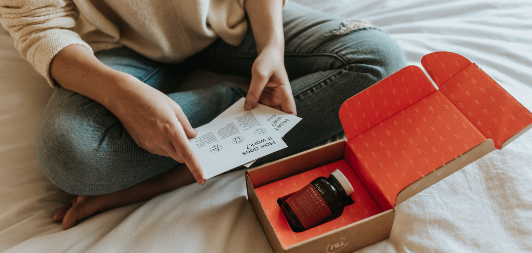 girl opening a package with medicines